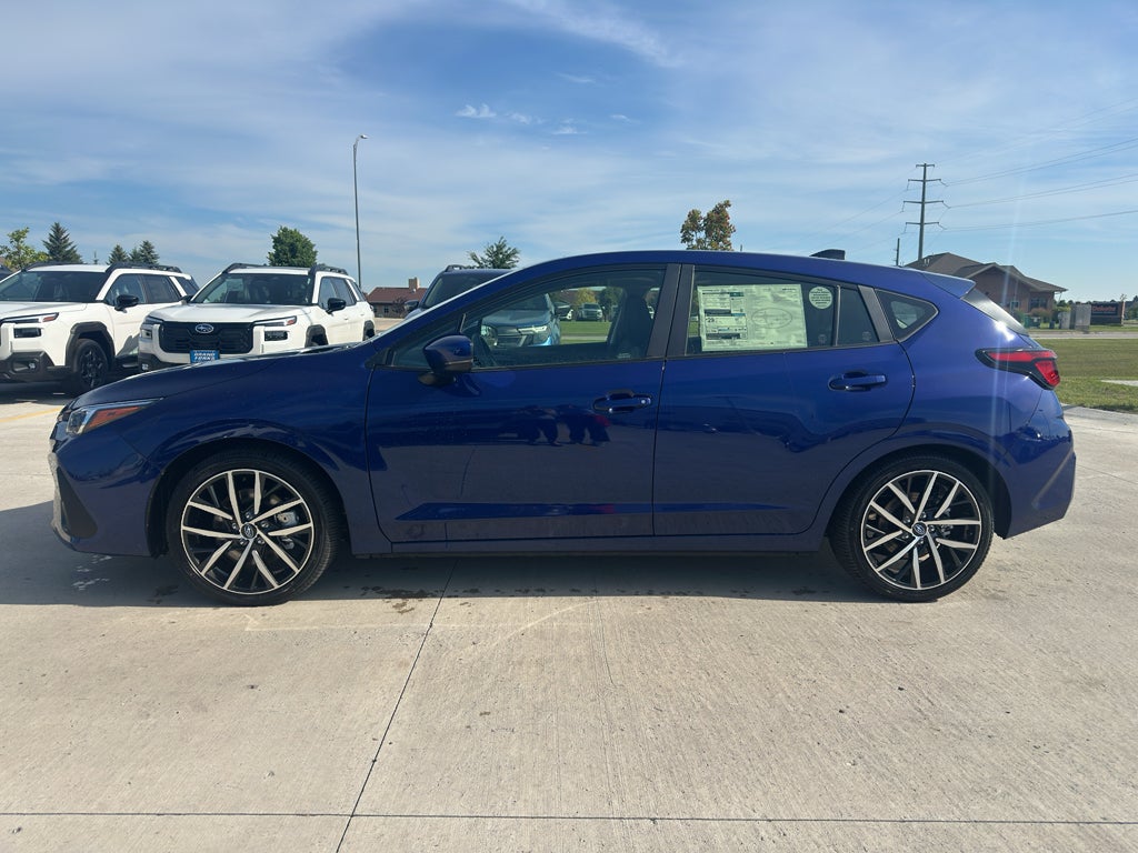 2026 Subaru IMPREZA Sport in Sapphire Blue Pearl — front three-quarter view